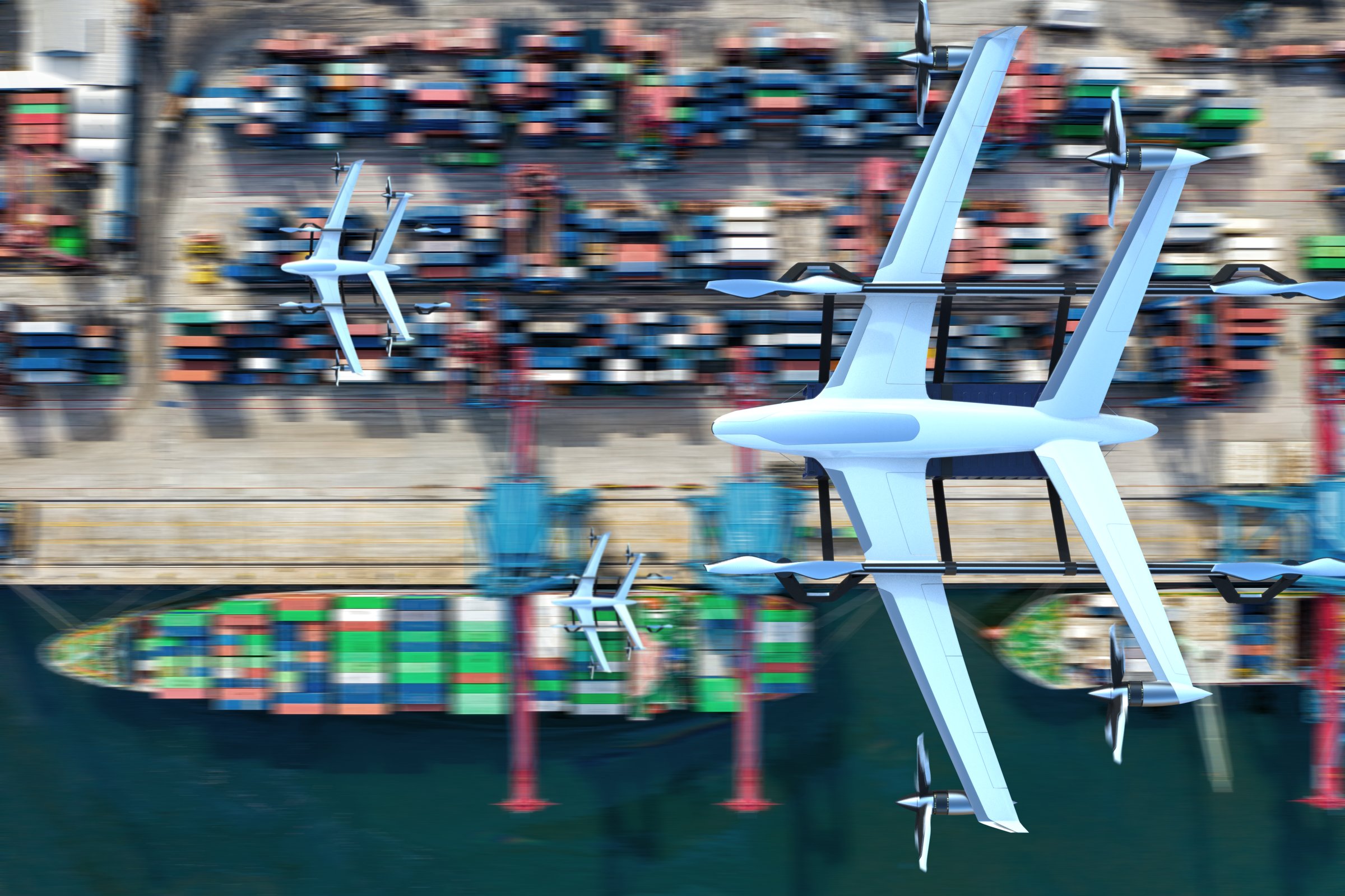 eCargo multirotor lifting a container alongside a container ship
