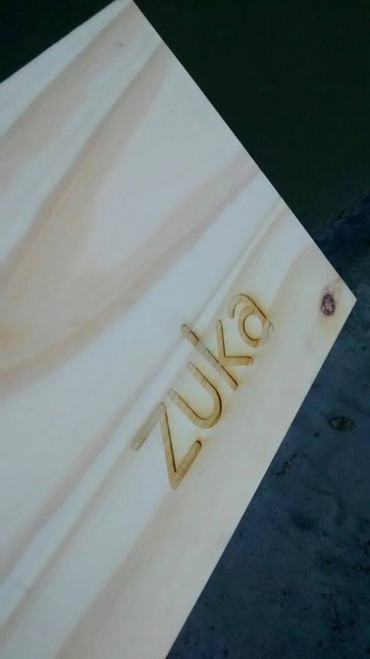 Zuka logo engraved into the pine cladding
