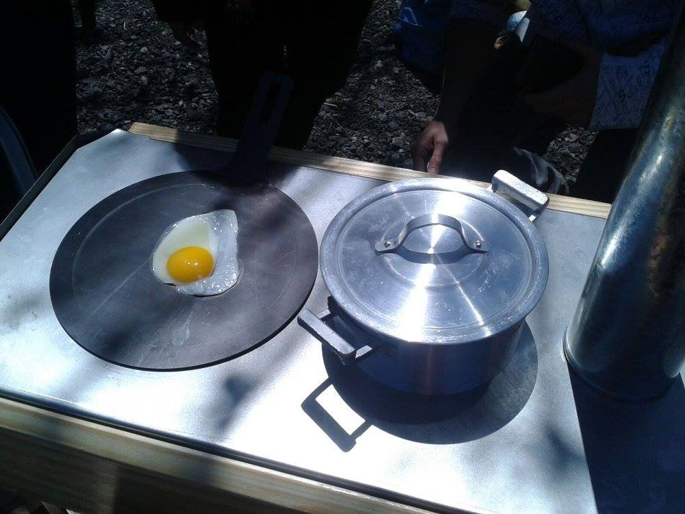 Frying an egg and a pot simmering on the Zuka cooktop